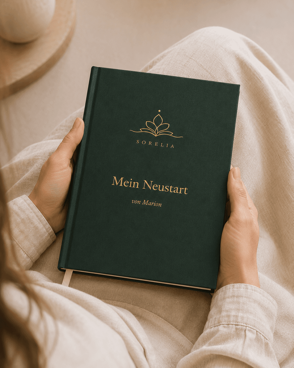 Ein grünes Sorelia-Buch mit Goldprägung, in zwei Händen gehalten.